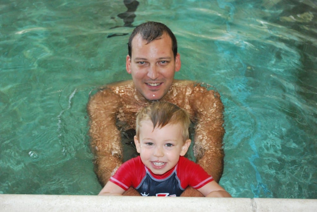Father and son enjoying swimming lessons at Blue Wave