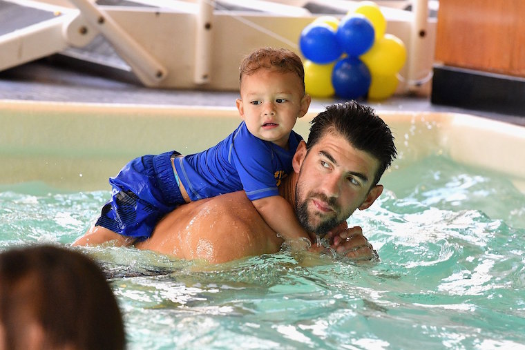 Michael Phelps with his toddler son in swimming pool