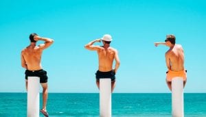 three people looking at water and sea