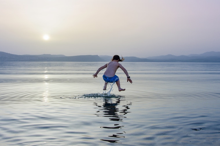 a kid is swimming in open water