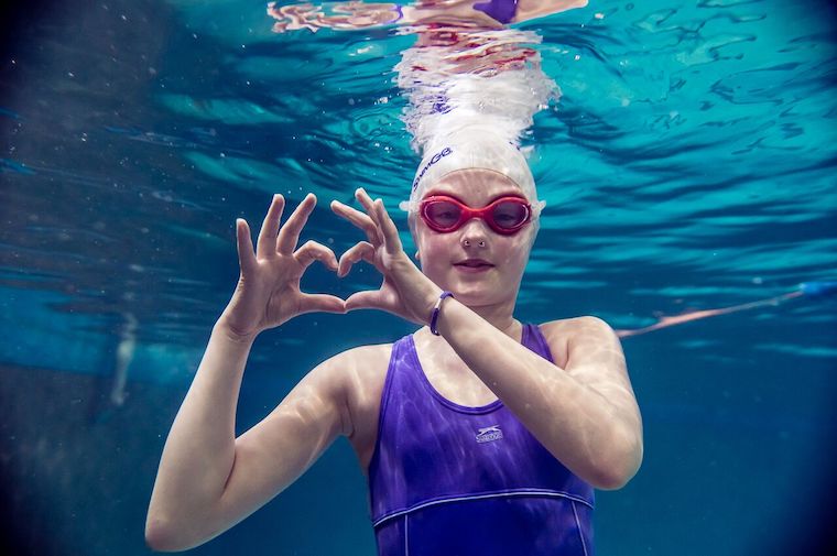 a child shows love swimming