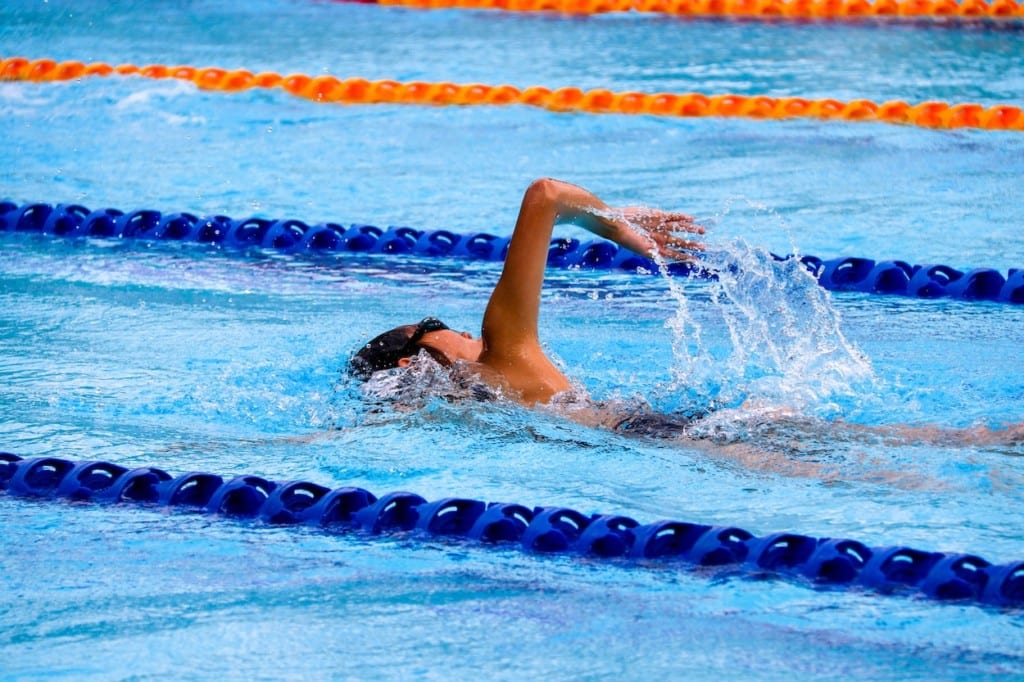an school aged child swimming in a pool